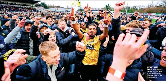  ?? ?? HEART AND SOLE: Maidstone forward Liam Sole is surrounded by jubilant fans at the final whistle