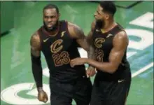 ?? CHARLES KRUPA — THE ASSOCIATED PRESS ?? Cleveland’s LeBron James and Tristan Thompson (13) celebrate near the end of the second half in Game 7 of the Eastern Conference finals on Sunday in Boston.