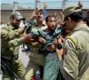  ??  ?? The police detains Saakshar Bharat Mission employees during a protest in support of their long- pending demands, including release of their pending salaries, outside the Civil Secretaria­t in Srinagar on Monday.
