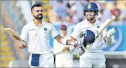  ?? AP ?? Virat Kohli celebrates his century, applauded by Umesh Yadav on the second day of the first Test against England at Edgbaston