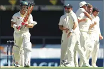  ??  ?? SEND OFF: England’s players enjoy the wicket of David Warner in the first Ashes Test