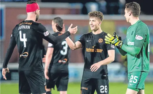  ?? SNS. ?? Happy birthday: Matty Smith is congratula­ted by a patched up Mark Durnan and goalkeeper Harry Lewis at the final whistle.