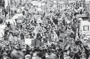  ?? Markus Schreiber / Associated Press ?? People attend a rally as part of a Fridays for Future global climate strike in Berlin. The idea for a global “climate strike” was inspired by teenage Swedish activist Greta Thunberg.