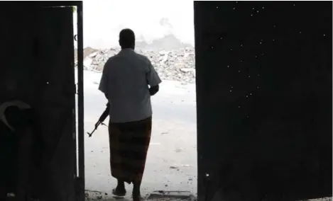  ?? MICHELLE SHEPHARD/TORONTO STAR FILE PHOTO ?? Bullet holes mark the door at the entrance of Mogadishu’s courthouse. An assault by a team of Shabab commandos, led by Canadian Mahad Dhore, killed 29 in 2013. Dhore was looking for something — a void that Al Shabab filled.