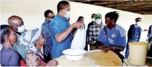  ??  ?? President Edgar Lungu buys rice from a rice trader at Kasoma Lunga market in Lunga district, Luapula Province yesterday. Picture by EDDIE MWANALEZA/STATE HOUSE