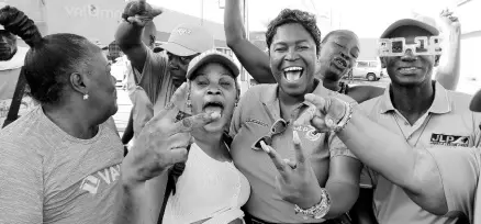  ?? PHOTOS BY NATHANIEL STEWART/PHOTOGRAPH­ER ?? Tanyalee Williams (centre), councillor for the May Pen North division, with JLP supporters in Bargain Village, May Pen, Sunday morning.