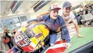  ??  ?? Honda’s Marc Marquez and teammate Dani Pedrosa pose for a photograph during a fan event in Tokyo.