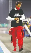  ?? MARK THOMPSON/ GETTY IMAGES ?? Sebastian Vettel of Germany walks to the grid during the F1 Grand Prix of Sakhir in Bahrain on Sunday.
