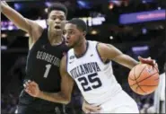  ?? CHRIS SZAGOLA — THE ASSOCIATED PRESS ?? Villanova’s Mikal Bridges, right, drives to the basket against Georgetown’s Jamorko Pickett during the first half of Saturday’s college basketball game in Philadelph­ia.