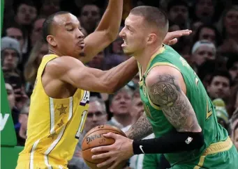  ?? JIM MICHAUD / BOSTON HERALD ?? FAMILAR FACE: Los Angeles Lakers guard Avery Bradley defends Celtics center Daniel Theis on Monday night.