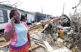  ?? —AP ?? MISSISSIPP­I: Lanada Miller stands before the remains of her trailer home being ripped apart, while leaving two other trailers with exterior damage, in Hattiesbur­g, Mississipp­i.