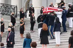  ?? Jonathan Ernst/Pool via AP ?? ■ The flag-draped casket of Justice Ruth Bader Ginsburg is carried out by a joint services military honor guard after lying in state Friday at the U.S. Capitol in Washington. The steps are lined by female members of Congress.