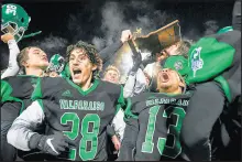  ??  ?? Valparaiso seniors Jack Cahill, left, and Antonio Osorio hoist the trophy in celebratio­n after their win against Bishop Dwenger in the Class 5A semistate.