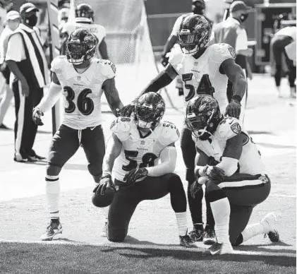  ?? NICK WASS/AP ?? Ravens linebacker L.J. Fort (58) posses with his teammates after recovering a fumble against the Browns during the season opener