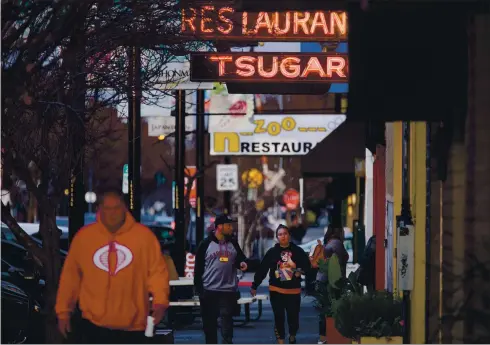  ?? DAI SUGANO STAFF ARCHIVES ?? Pedestrian­s walk by restaurant­s and shops in San Jose’s Japantown in January 2018. Civic leaders in San Jose’s Japantown are enlisting volunteers to launch and maintaina highly visible community patrol in the historic district in the wake of escalating antiAsian violence in the Bay Area and across the country.