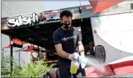  ?? RANDY VAZQUEZ — STAFF ARCHIVES ?? Owner and chef Randy Musterer disinfects tables at his restaurant Sushi Confidenti­al in San Jose in September 2020.