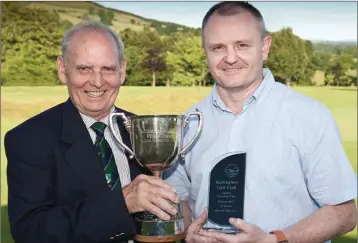  ??  ?? Derek Byrne receives the Junior Scratch Cup, sponsored by Jim Murray, from Baltinglas­s Golf Club Captain Louie Fagan.