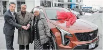  ?? RAY SPITERI TORSTAR ?? Vince Sasso, a sales representa­tive at Falls Chevrolet Cadillac Buick GMC, hands over the keys for a 2021 Cadillac XT4 Sport SUV to David and Sandra Jugoon. Their son, Peter and daughter-in-law, Susan, bought it for their 50th wedding anniversar­y.