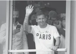  ?? FRANCOIS MORI/AP ?? Lionel Messi waves to fans after arriving at Le Bourget airport, near Paris on Tuesday ahead of a signing a two-year deal to join French power Paris Saint-germain.