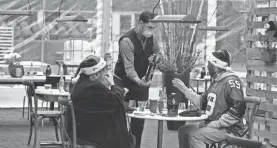  ?? AP ?? A server offers dining Seahawks fans a bottle of wine at Lumen Field.