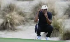  ?? DANTE CARRER/THE ASSOCIATED PRESS ?? Tiger Woods had a 3-under 69 in the opening round of the Hero World Challenge on Thursday in Nassau, Bahamas, three shots off the lead.