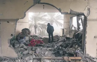  ?? ?? A Palestinia­n inspects a damaged building following an Israeli airstrike on the Rafah refugee camp, Gaza Strip, Palestine, Feb. 9, 2024.