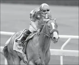  ?? Mark Lennihan Associated Press ?? JUSTIFY DIDN’T RACE as a 2-year-old last year, not even in the Breeders’ Cup, and he still went on to win the Triple Crown under jockey Mike Smith.