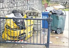  ?? (Photo: John O’Connell) ?? A Skippo bag, surrounded by litter seen in recent weeks near the slipway to the river, adjacent to Brian Boru Square.