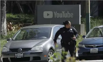  ?? AP PHOTO/JEFF CHIU ?? An o cer runs past a YouTube sign near the company’s complex in San Bruno, on Tuesday. A woman opened fire at YouTube headquarte­rs Tuesday, setting o a panic among employees and wounding several people before fatally shooting herself, police and...