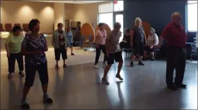  ?? TYLER RIGG — THE NEWS-HERALD ?? Seniors participat­e in an intermedia­te line dancing class on Aug. 13 at Willoughby’s David E. Anderson Senior Center.