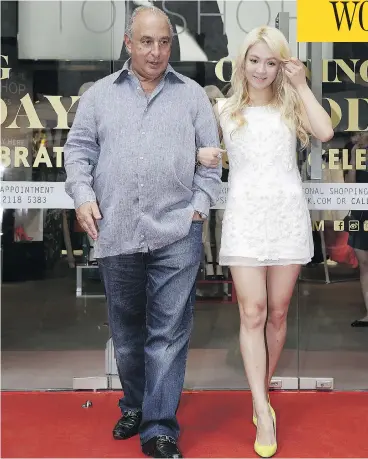  ?? JESSICA HROMAS / GETTY IMAGES ?? Fashion mogul Sir Philip Green, shown here in 2013 with pop singer Kim Hyo-yeon, obtained a court injunction to stop the Daily Telegraph from running stories about employee allegation­s of sexual harassment and racial abuse.