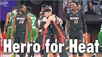  ?? Getty Images ?? TY GAME: The Heat’s Tyler Herro, just 20 years old, celebrates with his teammates after scoring 37 points in a 112-109 win over the Celtics that put Miami one win from the NBA Finals.