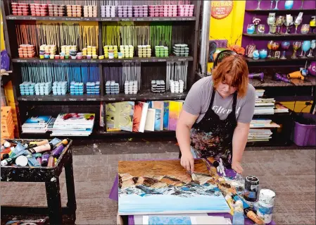  ?? TIM MARTIN/THE DAY ?? Felicia Stevens of New London, owner of the Drunken Palette located on State Street in New London, uses acrylics to paint an Afghanista­n scene from a patron’s photograph Wednesday. The establishm­ent will celebrate its seventh year in business on Nov. 30.