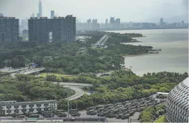  ?? Getty Images ?? China police trucks and armored vehicles park near a bridge linking mainland China to Hong Kong.