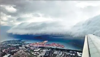  ?? ALEX TILLMAN / REUTERS ?? A storm cloud is seen from a plane in Sydney, Australia, on Friday. This still image is taken from a video obtained from social media on Saturday.