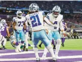  ?? ADAM BETTCHER/GETTY ?? Ezekiel Elliott celebrates with QB Dak Prescott after rushing for a touchdown in the Cowboys’ 40-3 rout of the Vikings on Sunday in Minneapoli­s.