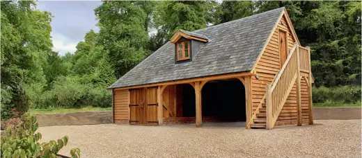  ??  ?? Below: Designed by The Classic Barn Company, this threebay garage and car port has living space above, accessed via an external staircase