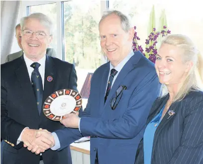  ??  ?? David During, left, presents the Centenary Plate to Nick Wood and Helen Bolam