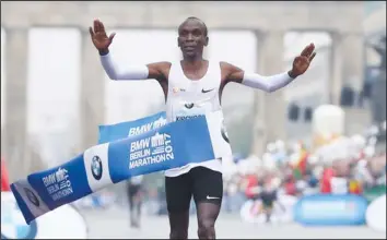  ?? — Reuters ?? HOME ALONE . . . Kenya’s Eliud Kipchoge crosses the finish line first to win the Berlin marathon in Germany yesterday.