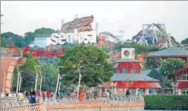  ?? AP ?? People walk around Sentosa Island, where the Usnorth Korea summit will take place.