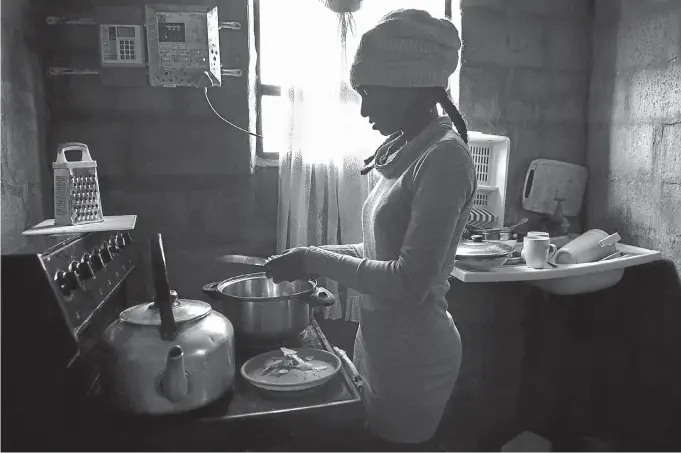  ?? Picture: © Leonette Bower ?? STEADFAST Faith Moyo works in the kitchen of her family’s home in Rocklands, Port Elizabeth. As a pupil she helped make ends meet by selling school lunches to other kids, and later worked her way through university.