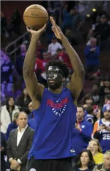  ?? CHRIS SZAGOLA — THE ASSOCIATED PRESS ?? The Sixers’ Joel Embiid wears a mask while warming up Wednesday at Wells Fargo Center. Embiid has been officially declared out for the Sixers’ first-round playoff series against the Miami Heat, which starts Saturday in Philadelph­ia.