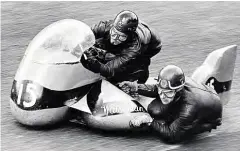  ??  ?? 1962, and Chris Vincent powers his BSA outfit around Cadwell Park with passenger Eric Bliss.