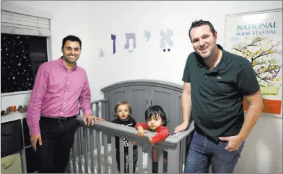 ?? Jae C. Hong The Associated Press file ?? Elad Dvash-banks, left, and his partner, Andrew, with their twin sons, Ethan, center right, and Aiden in their Los Angeles apartment in January 2018. A federal judge in California has ruled that a twin son of the gay couple has been an American citizen since birth, handing a defeat to the U.S. government, which had only granted the status to his brother.