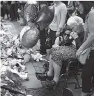  ?? THE ASSOCIATED PRESS ?? Women cry after placing flowers in a square in central Manchester, Britain, on Wednesday after an attack at an Ariana Grande concert that left 22 people dead.