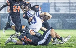  ?? SCOTT ASH / NOW NEWS GROUP ?? Hartford's Seth Kuchinski (on ground) helps take down Whitefish Bay running back Bo Bassindale during a recent game.