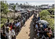  ?? BLOOMBERG ?? Rohingya peoplewait in line for supplies at a refugee campin Bangladesh on Sept. 21, 2017. Some700,000 Rohingya flfled their homes for neighborin­g Bangladesh after a brutal military campaign last year.