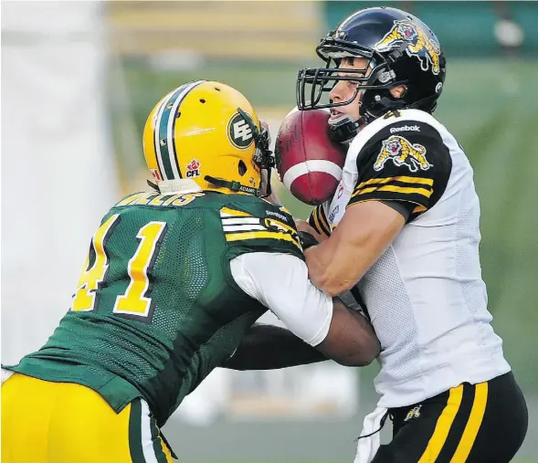  ?? ED KAISER/EDMONTON JOURNAL ?? Eskimos defensive end Odell Willis knocks the ball loose as he hits Hamilton Tiger-Cats quarterbac­k Zach Collaros Friday during Edmonton’s 28-24 win.