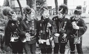  ??  ?? Participan­ts clad in traditiona­l happi coats get ready for a selfie before the Chichibu Night Festival.