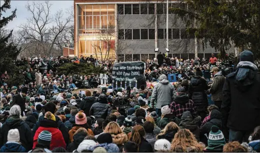  ?? NICK HAGEN/THE NEW YORK TIMES ?? Mourners gather for a vigil at the Rock on Michigan State’s campus in East Lansing on Wednesday. The Rock has been used as a billboard for various student movements over the decades. While university offices reopened, some are calling for more time for students to grieve rather than going back to class soon.